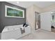 Bathroom featuring a soaking tub with a large window and a separate glass-enclosed shower at 332 Mount Zion Rd, Oxford, GA 30054