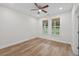 Bedroom with ceiling fan, wood-look floors, two windows with green wooded view at 332 Mount Zion Rd, Oxford, GA 30054