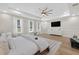 Large bedroom featuring a decorative ceiling fan and a mounted TV with a cozy sitting area at 332 Mount Zion Rd, Oxford, GA 30054