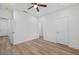 A spacious bedroom with wood floors, white walls, a ceiling fan and doors at 332 Mount Zion Rd, Oxford, GA 30054