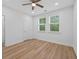Bright bedroom featuring hardwood floors, a ceiling fan, and two large windows at 332 Mount Zion Rd, Oxford, GA 30054