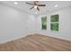 Empty bedroom with hardwood floors, two windows, and a ceiling fan with lighting at 332 Mount Zion Rd, Oxford, GA 30054