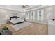 Spacious bedroom with hardwood floors, ensuite bathroom, and lots of natural light from several windows at 332 Mount Zion Rd, Oxford, GA 30054