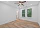 Bedroom with two windows with wood-look flooring, ceiling fan, and light neutral walls at 332 Mount Zion Rd, Oxford, GA 30054