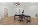 Large bedroom with hard floors, a ceiling fan and a large work desk with rolling chair at 332 Mount Zion Rd, Oxford, GA 30054