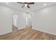 Neutral bedroom with ceiling fan, and wood-look flooring leads to bathroom and closet at 332 Mount Zion Rd, Oxford, GA 30054
