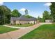 Well-maintained home showcasing a long driveway, detached garage, and beautifully landscaped surroundings at 332 Mount Zion Rd, Oxford, GA 30054