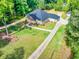 Aerial view of a home with a large lot, long driveways and surrounded by green trees at 332 Mount Zion Rd, Oxford, GA 30054