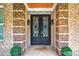 Close-up of a brick entryway and decorative double front doors, adding a touch of elegance at 332 Mount Zion Rd, Oxford, GA 30054