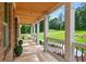 Spacious covered porch with white columns and decorative railings, offering a tranquil outdoor space at 332 Mount Zion Rd, Oxford, GA 30054