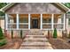 Inviting front porch with decorative columns and iron railings leading to the front entrance at 332 Mount Zion Rd, Oxford, GA 30054