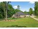 Charming single-story home featuring a welcoming front porch and a lush, well-manicured lawn at 332 Mount Zion Rd, Oxford, GA 30054