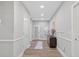 Hallway with grey walls, wood floors, wainscoting, and a decorative cabinet and mirror at 332 Mount Zion Rd, Oxford, GA 30054