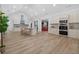 A well lit, spacious kitchen with stainless steel appliances, island with seating, and open floor plan at 332 Mount Zion Rd, Oxford, GA 30054