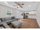 Open-concept living room seamlessly connected to the kitchen, featuring a gray sectional couch at 332 Mount Zion Rd, Oxford, GA 30054