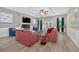 Spacious living room boasts a ceiling fan, fireplace, wainscotting, hardwood floors, and neutral paint at 332 Mount Zion Rd, Oxford, GA 30054