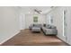 Cozy living room with gray sectional couch, ceiling fan, and lots of natural light at 332 Mount Zion Rd, Oxford, GA 30054