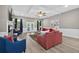 Bright living room with hardwood floors, a ceiling fan, fireplace and french doors to the backyard at 332 Mount Zion Rd, Oxford, GA 30054