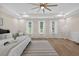 Spacious main bedroom boasts tray ceilings, ceiling fan, three windows, and wood-look flooring at 332 Mount Zion Rd, Oxford, GA 30054