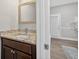 Bathroom vanity with a light countertop, dark cabinets, and a gold mirror in a modern style at 332 Mount Zion Rd, Oxford, GA 30054