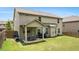 Spacious backyard featuring a covered patio, lush green grass, and privacy fencing at 6213 Old Kingston Dr, Atlanta, GA 30331