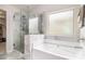 Bathroom featuring a glass-enclosed shower, soaking tub, and a window, providing a spa-like experience at 6213 Old Kingston Dr, Atlanta, GA 30331
