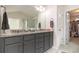 Bathroom with dual vanity, granite countertop, and a walk-in closet, offering style and functionality at 6213 Old Kingston Dr, Atlanta, GA 30331