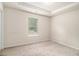 Bright, carpeted bedroom with a window allowing ample natural light into the space at 6213 Old Kingston Dr, Atlanta, GA 30331