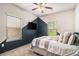 Stylish bedroom featuring color-blocked walls, a ceiling fan, and plush bedding near windows at 6213 Old Kingston Dr, Atlanta, GA 30331