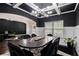 Sophisticated dining room with dark walls, an elegant chandelier, and a large wooden table with seating for six at 6213 Old Kingston Dr, Atlanta, GA 30331