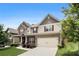 Beautiful two-story home boasts brick accents, red shutters, and a lush green lawn on a sunny day at 6213 Old Kingston Dr, Atlanta, GA 30331