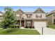Charming two-story home featuring brick and siding, a well-manicured lawn, and an attached two-car garage at 6213 Old Kingston Dr, Atlanta, GA 30331