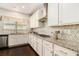 Bright kitchen featuring white cabinets, granite countertops, stainless steel appliances, and stylish backsplash at 6213 Old Kingston Dr, Atlanta, GA 30331