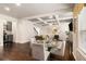 Open-concept living area with hardwood floors, coffered ceilings, and a glimpse of the modern kitchen at 6213 Old Kingston Dr, Atlanta, GA 30331