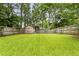 The expansive backyard showcases a shed, lush lawn, and privacy fence at 1148 Ne Hardee Ne St, Atlanta, GA 30307