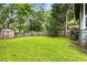 Green backyard provides ample space, a storage shed, and wood fencing at 1148 Ne Hardee Ne St, Atlanta, GA 30307