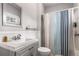 Neutral bathroom boasts a shower and tub combo with a modern vanity and lighting at 1148 Ne Hardee Ne St, Atlanta, GA 30307