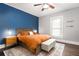 Inviting bedroom features colorful accent wall, ceiling fan and natural light at 1148 Ne Hardee Ne St, Atlanta, GA 30307