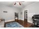 Neutral bedroom with a blue area rug, hardwood floors, and an attached room beyond a wide door frame at 1148 Ne Hardee Ne St, Atlanta, GA 30307
