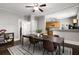 Dining room featuring a table and chairs with an area rug, hardwood floors, and an adjacent kitchen at 1148 Ne Hardee Ne St, Atlanta, GA 30307