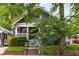 Inviting home with a cozy front porch, offering a blend of classic architecture and shaded surroundings at 1148 Ne Hardee Ne St, Atlanta, GA 30307