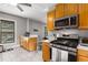 Kitchen features wood cabinets, modern appliances, tile floors, and a breakfast bar overlooking the dining room at 1148 Ne Hardee Ne St, Atlanta, GA 30307
