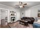 Cozy living room featuring hardwood floors, a fireplace, and comfortable leather seating at 1148 Ne Hardee Ne St, Atlanta, GA 30307