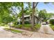 Charming house featuring a covered front porch, complemented by mature trees and landscaping at 1148 Ne Hardee Ne St, Atlanta, GA 30307