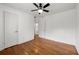 A bright bedroom is showcased with a ceiling fan, hardwood flooring, and an ensuite bathroom at 1355 Euclid Ne Ave # A8, Atlanta, GA 30307