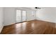 Open living area with hardwood floors, ceiling fan, and sliding doors to the balcony at 1355 Euclid Ne Ave # A8, Atlanta, GA 30307