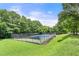 Community tennis court surrounded by lush green trees at 1355 Euclid Ne Ave # A8, Atlanta, GA 30307