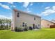 The backyard features a well-maintained lawn, a patio, and is bordered by shrubs and fencing at 1469 Cliff View Ter, Conyers, GA 30012