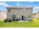 The backyard features a well-maintained lawn, a patio, and is bordered by shrubs and fencing at 1469 Cliff View Ter, Conyers, GA 30012