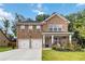 Charming two-story brick home with a well-manicured lawn and a two-car garage at 1469 Cliff View Ter, Conyers, GA 30012